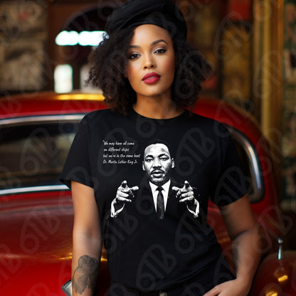 Woman wearing a t-shirt with a graphic of Martin Luther King Jr. and text, sitting in a car.