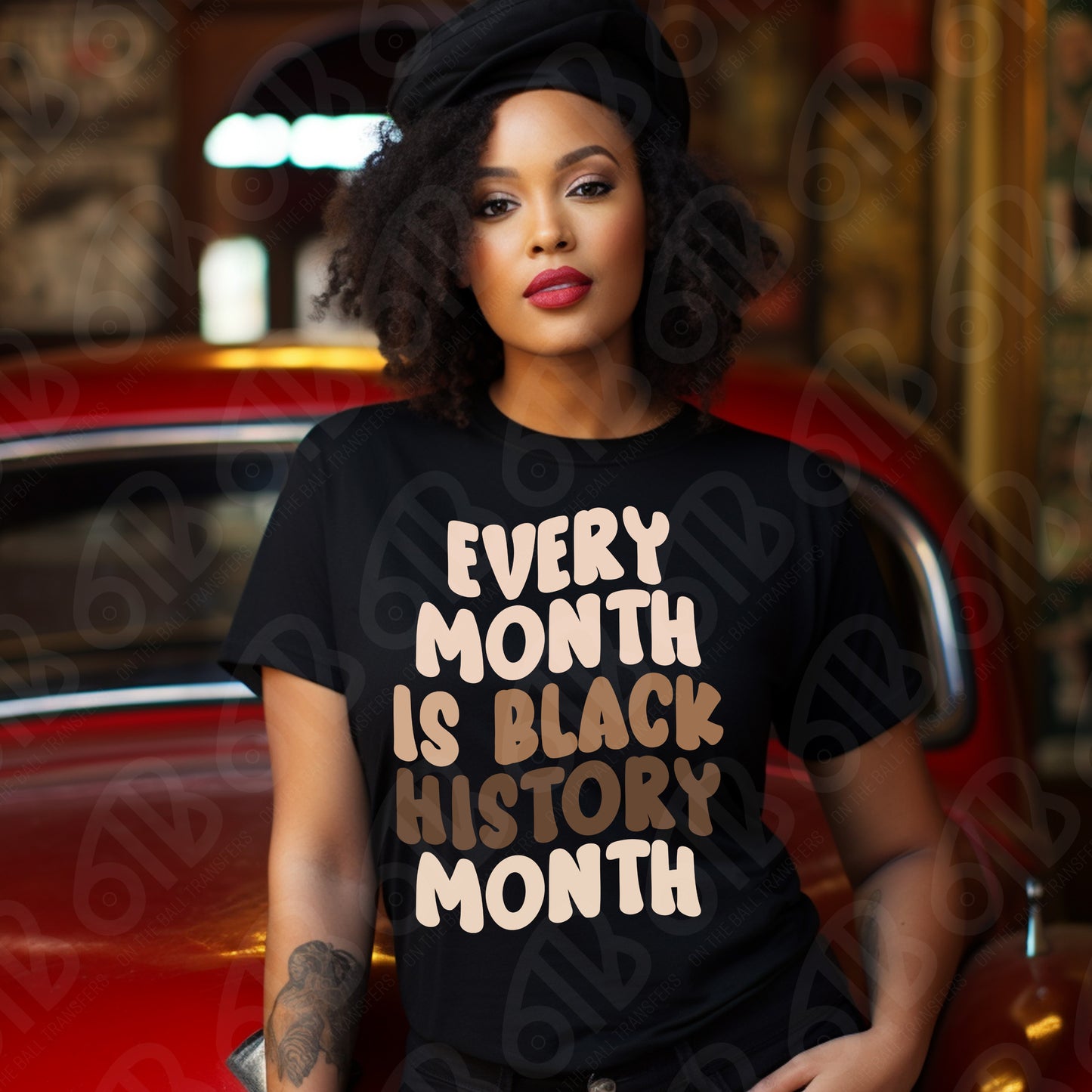 Woman wearing a black t-shirt with 'Every Month is Black History Month' text, sitting in a car.