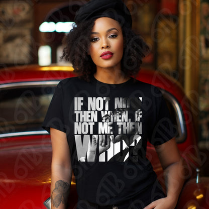 Woman wearing a black t-shirt with a quote of Malcolm X, sitting in front of a red car.