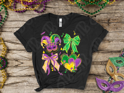 Black t-shirt with Mardi Gras-themed design on a wooden surface with festive beads and masks.