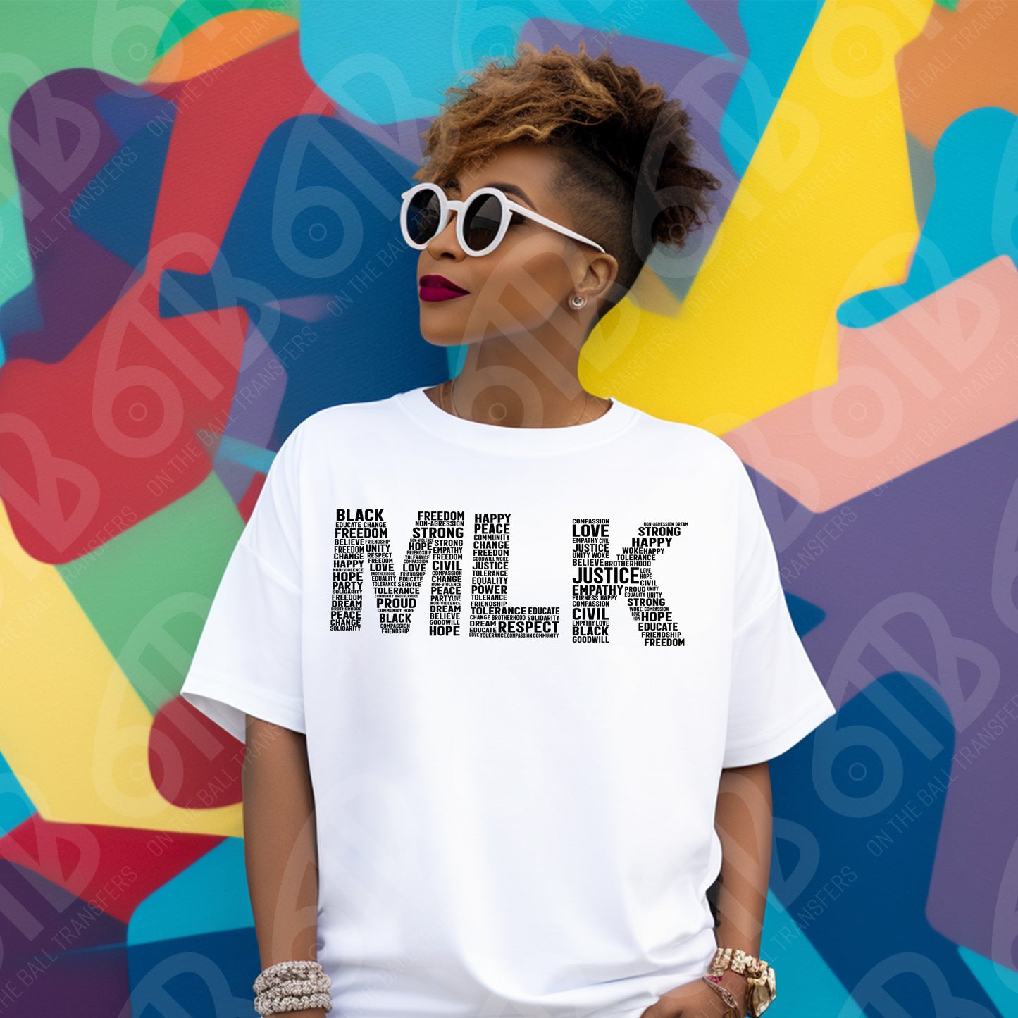Person wearing a white t-shirt with text about Martin Luther King Jr  in front of a colorful abstract background