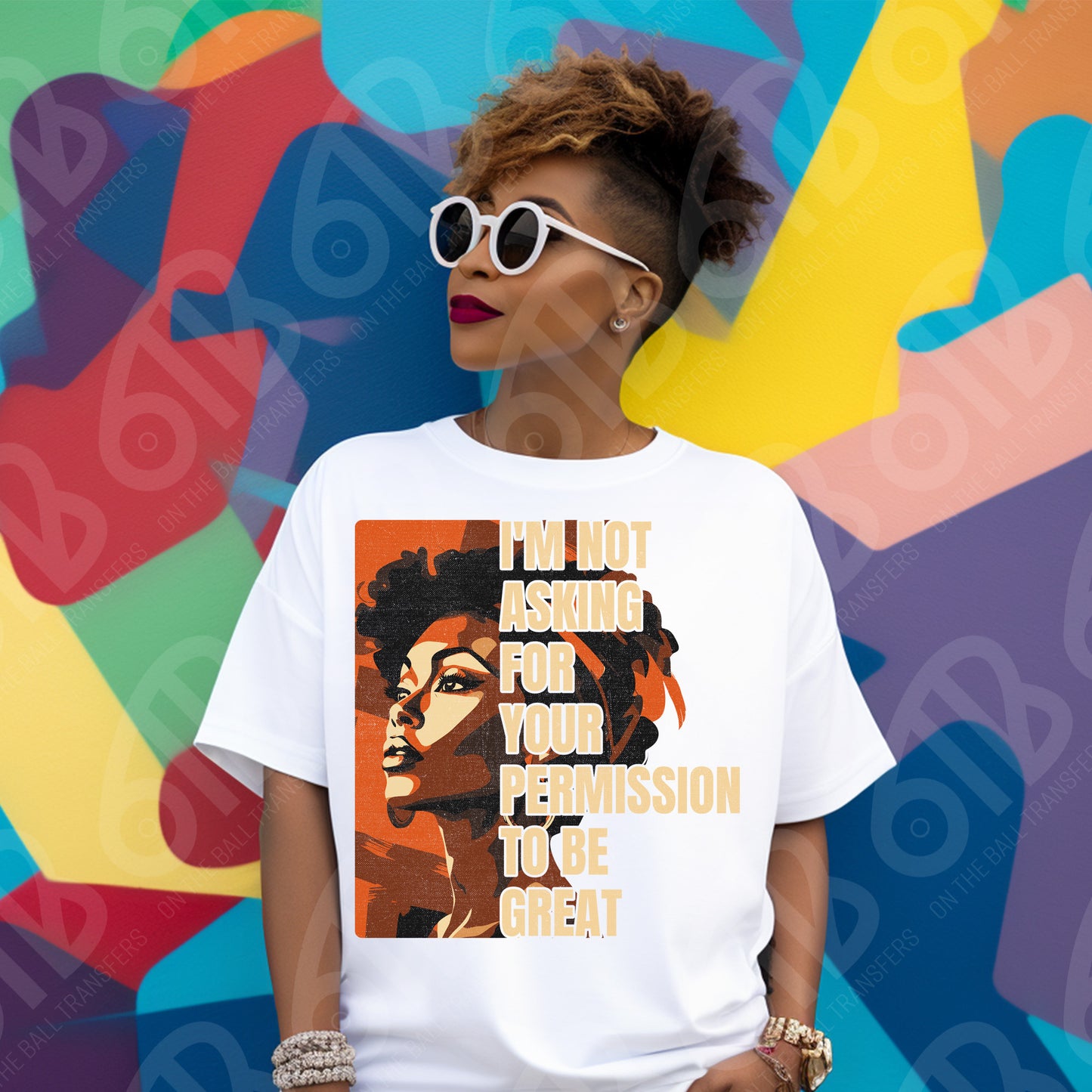 Person wearing a white t-shirt with a graphic and text, standing against a colorful abstract background